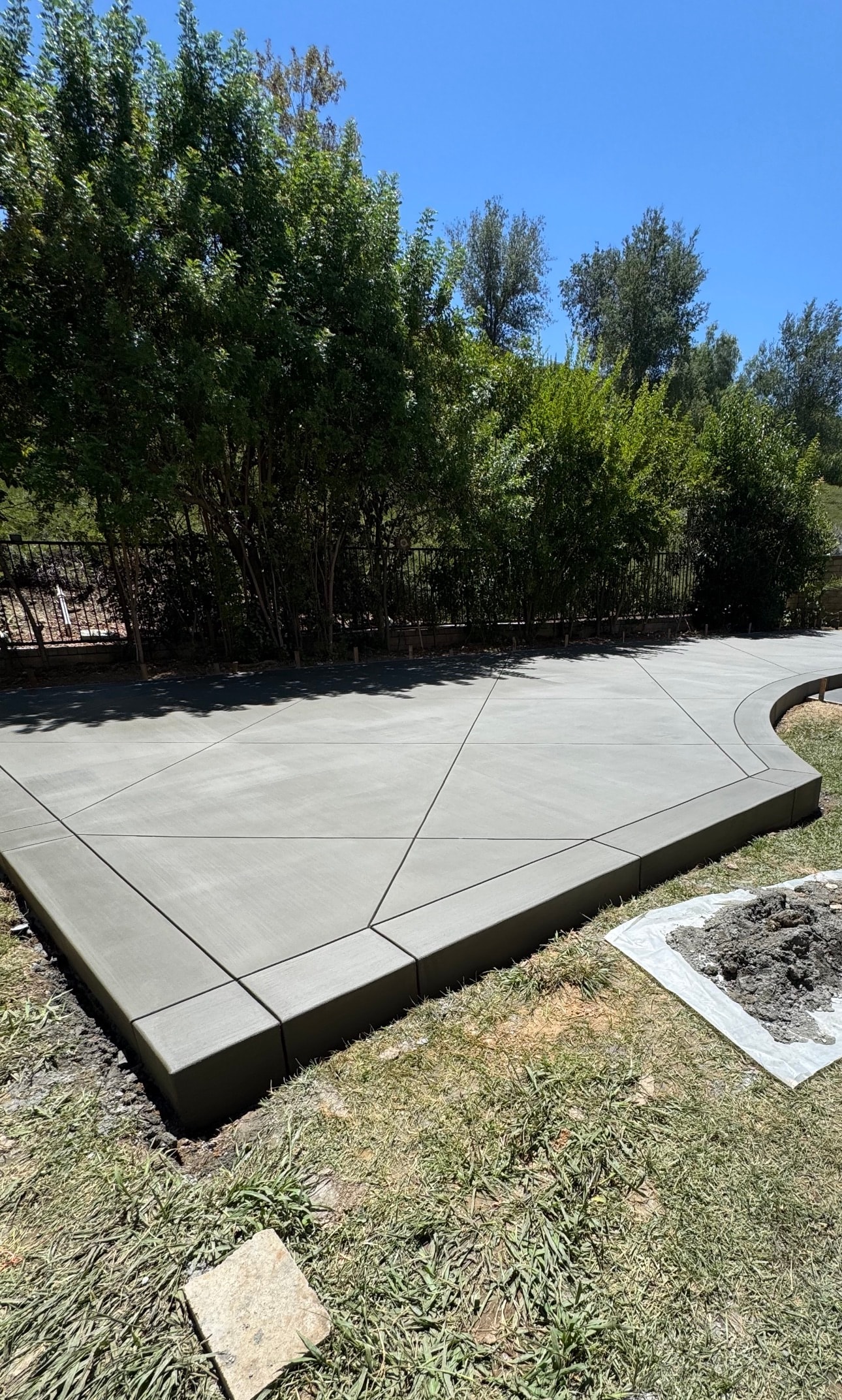 Completed broom finish concrete patio with decorative score lines in Santa Clarita — Concrete Etc., Inc.