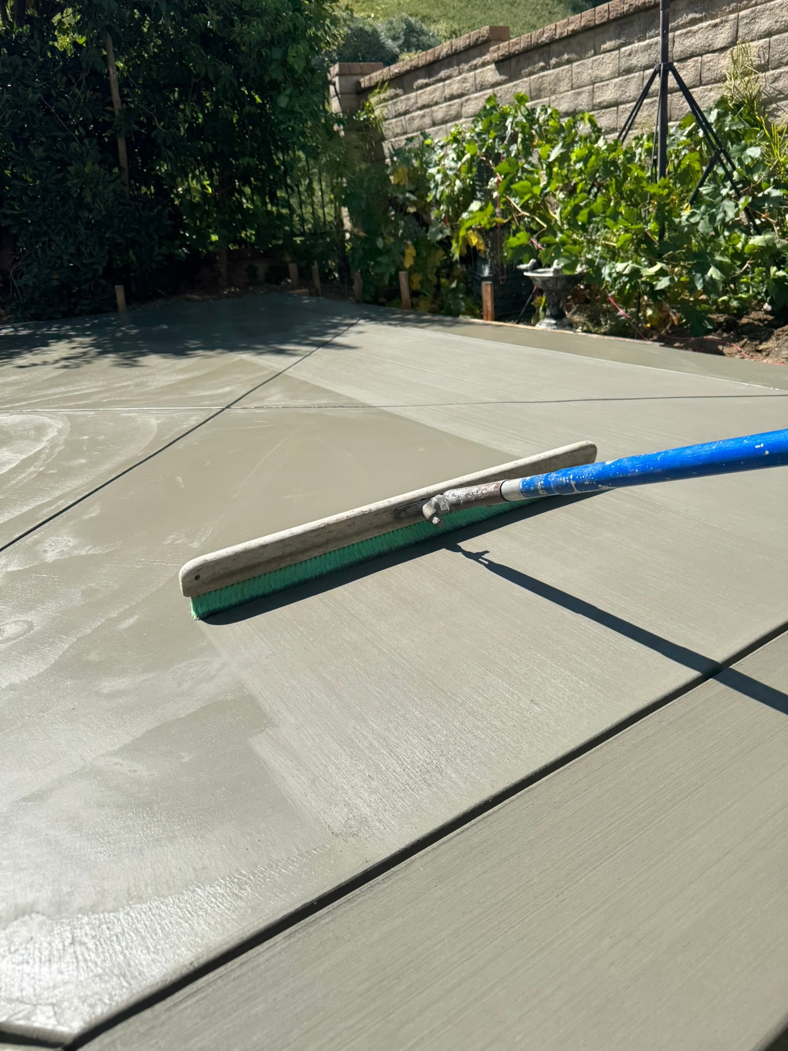 Concrete contractor finishing a broom finish patio in Santa Clarita — Concrete Etc., Inc.