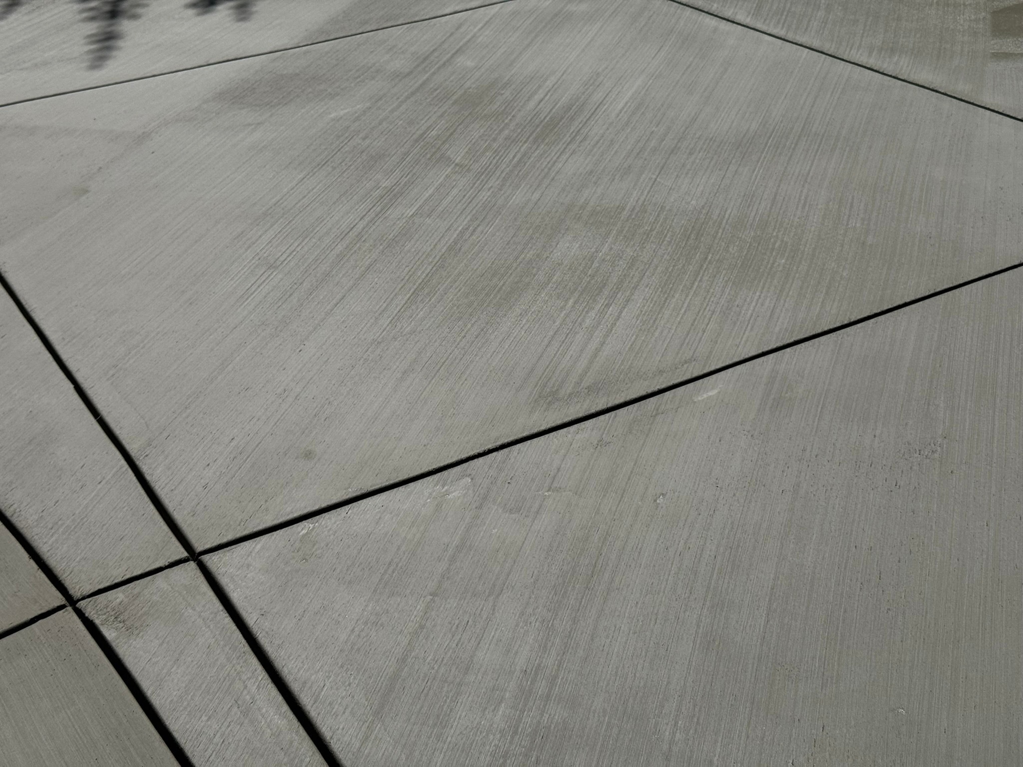 Close-up of broom finish concrete texture with control joints — Concrete Etc., Inc., Los Angeles County