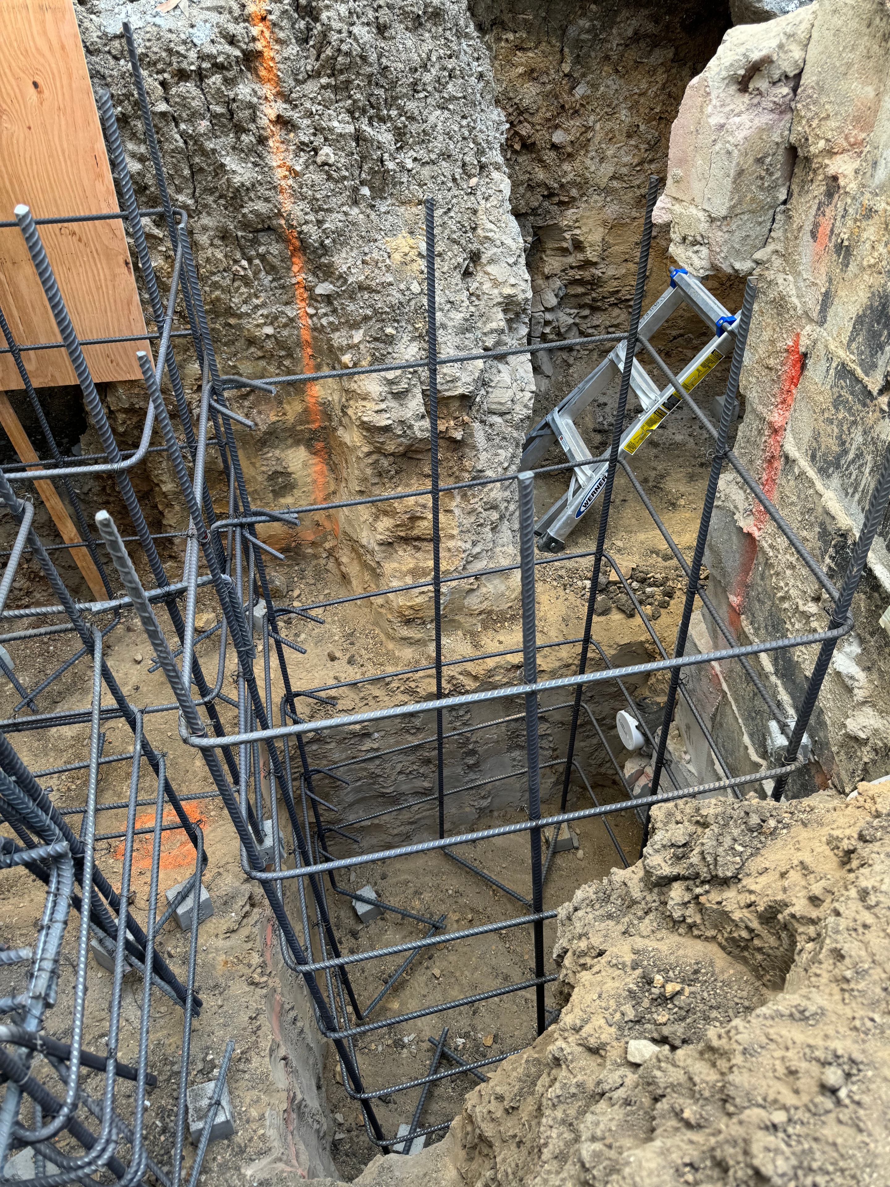 Close-up of heavy rebar cage and excavation sections for concrete foundation underpinning in Los Angeles, CA by Concrete Etc., Inc.