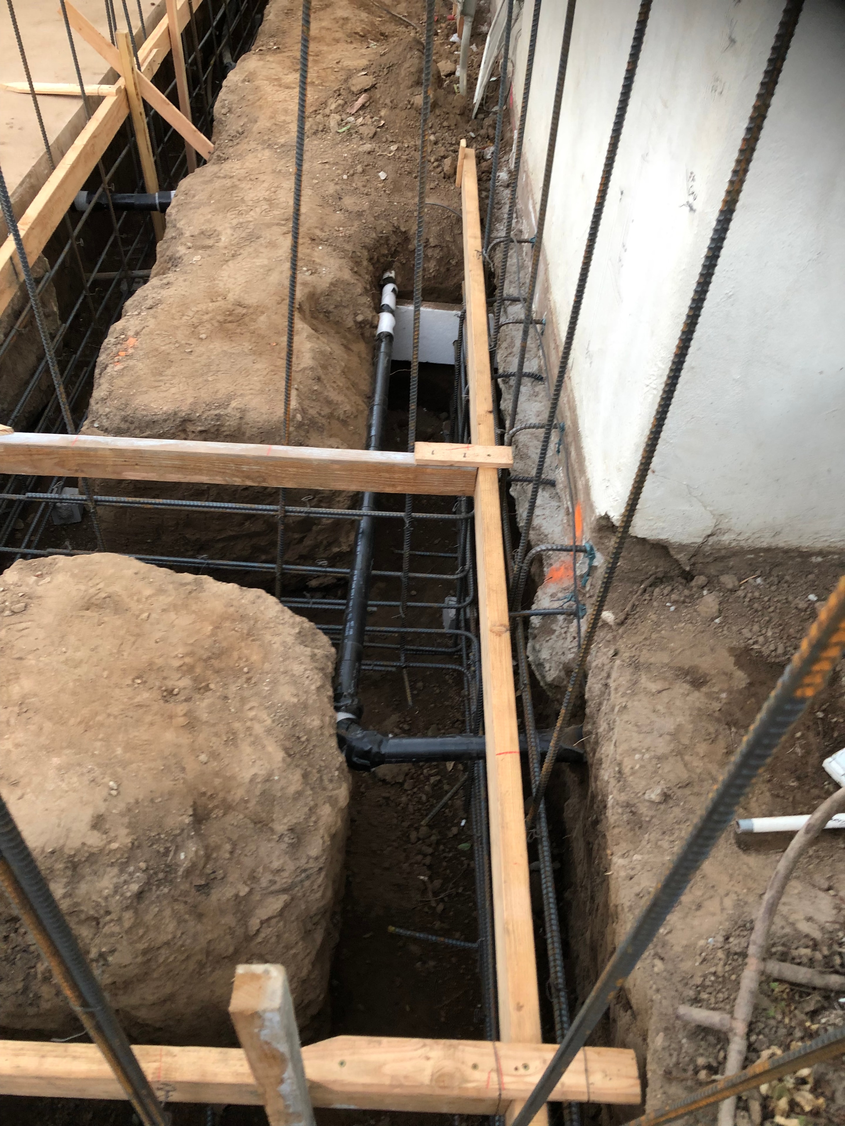 Concrete foundation underpinning excavation with rebar grid and existing footing exposed in Pasadena — Concrete Etc., Inc.