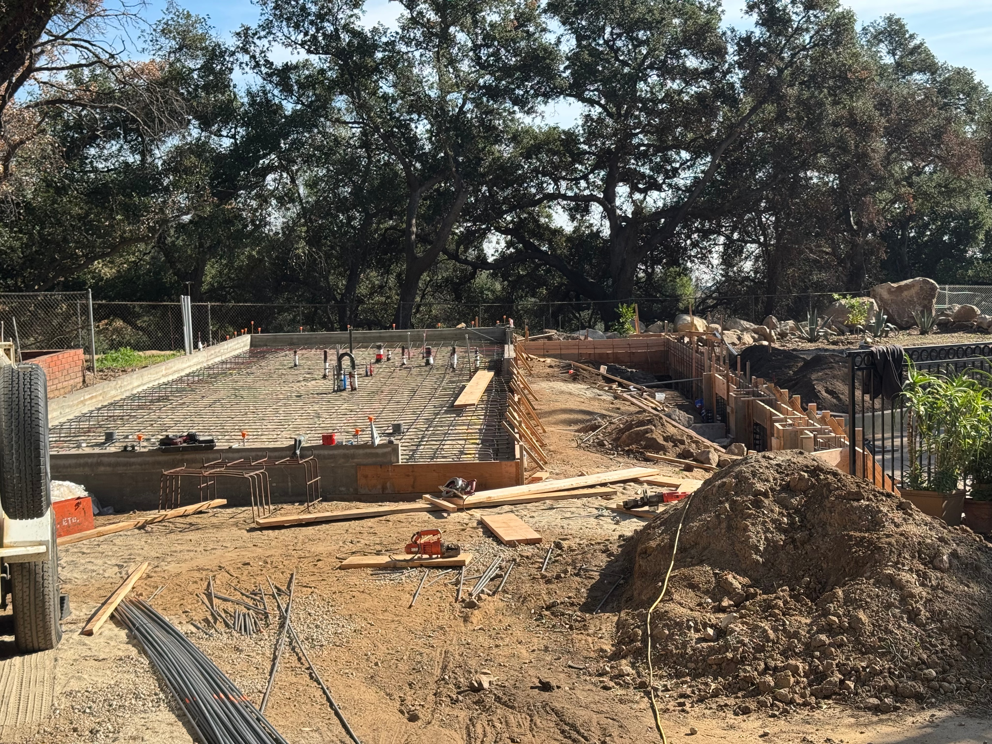 Concrete slab foundation with rebar mesh, footings and retaining wall under construction in Altadena, CA by Concrete Etc., Inc.