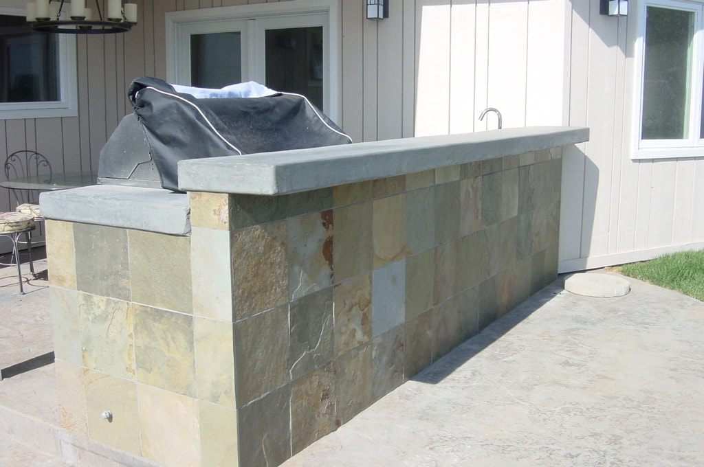 Outdoor bar with slate tile veneer and custom concrete countertop on concrete patio in Los Angeles by Concrete Etc., Inc.