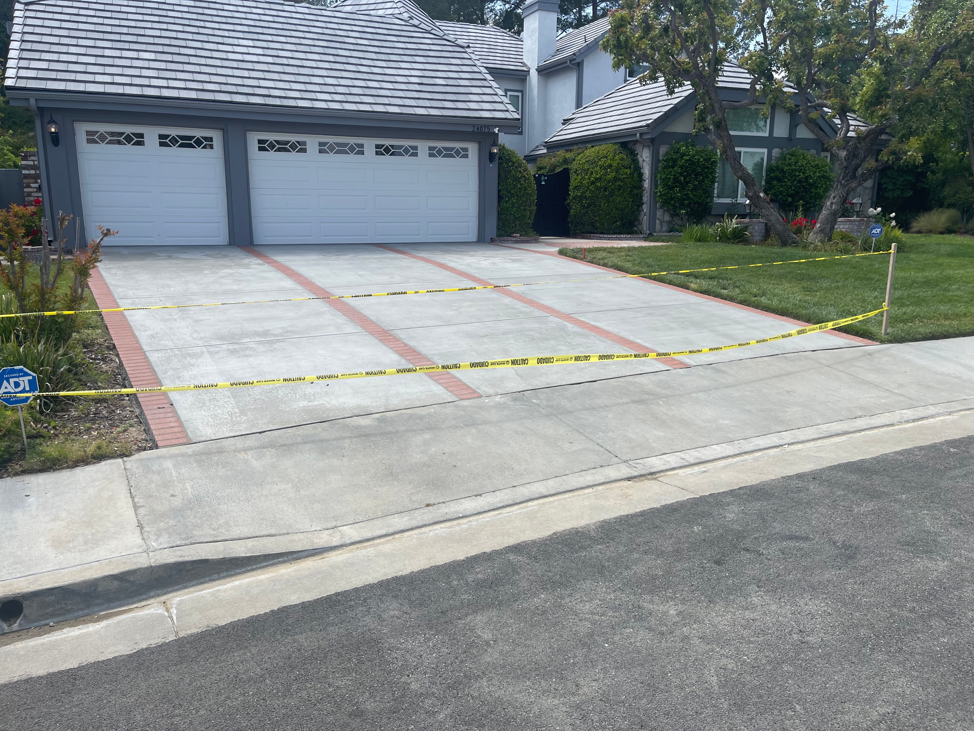 New concrete driveway with brick ribbons and border — Santa Clarita, CA