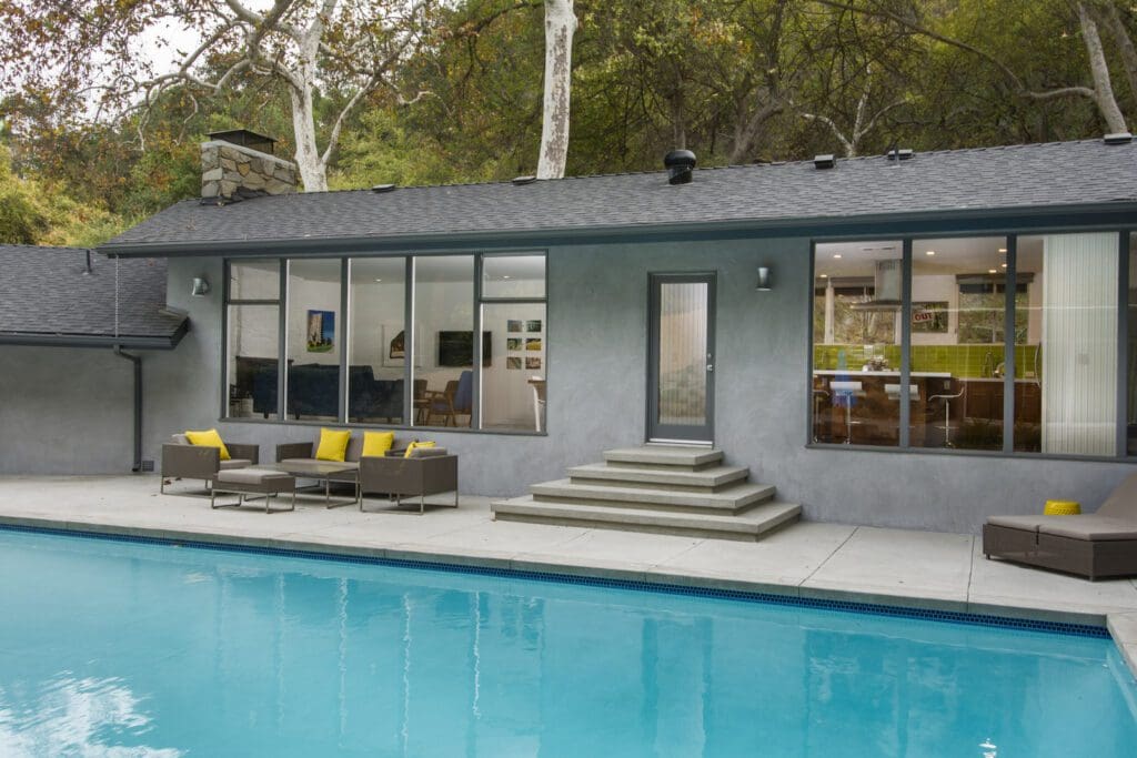 Sand finish concrete pool deck with steps and coping installed by top-rated concrete contractor in Santa Clarita