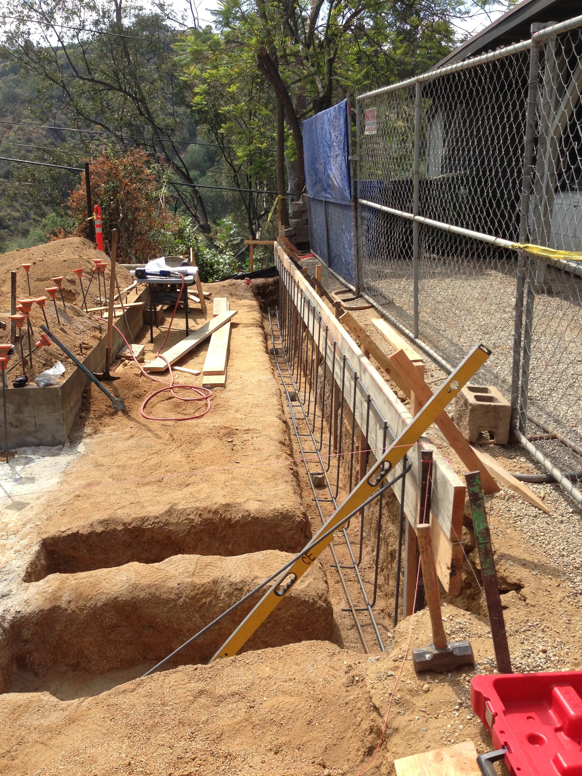 Concrete Etc. crew setting formwork and rebar for hillside foundation in Los Angeles County
